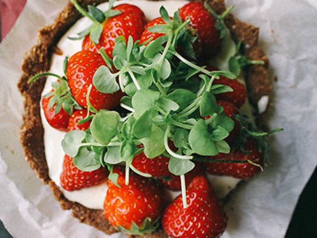 Individual Chocolate Tarts with Vanilla Cream Filling, Fresh Strawberries, and Cantaloupe Microgreens