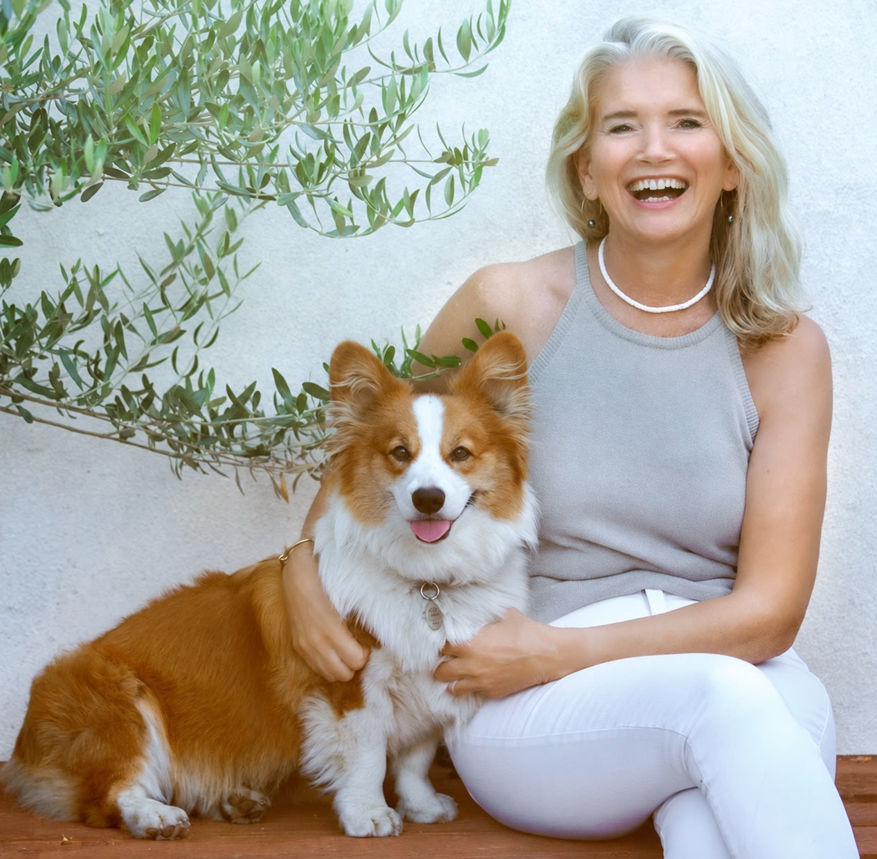 Jeanette, the founder of ZestiGreens, sitting with her dog Scooby